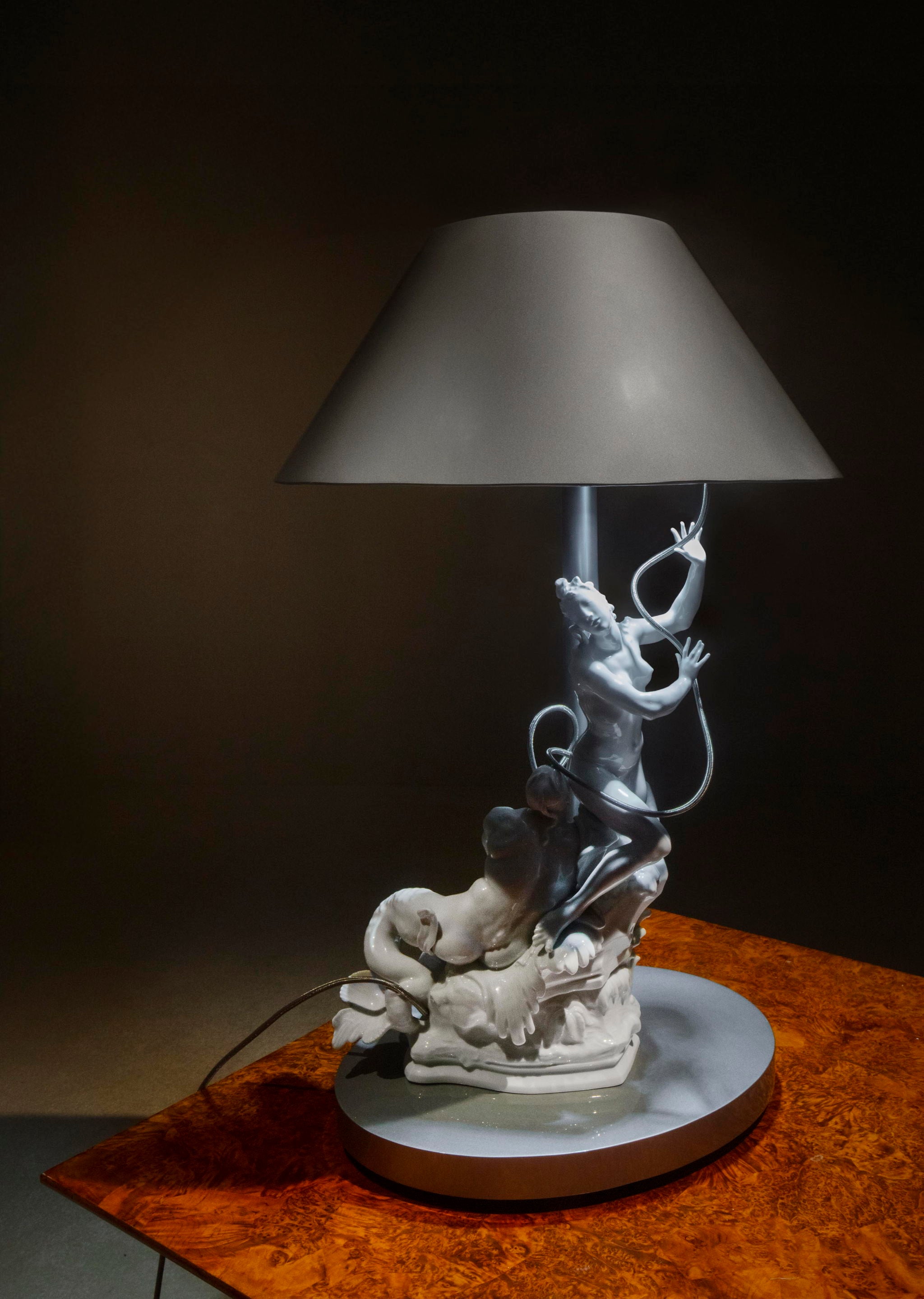 A decorative lamp featuring intricate animal figurines and a conical shade.