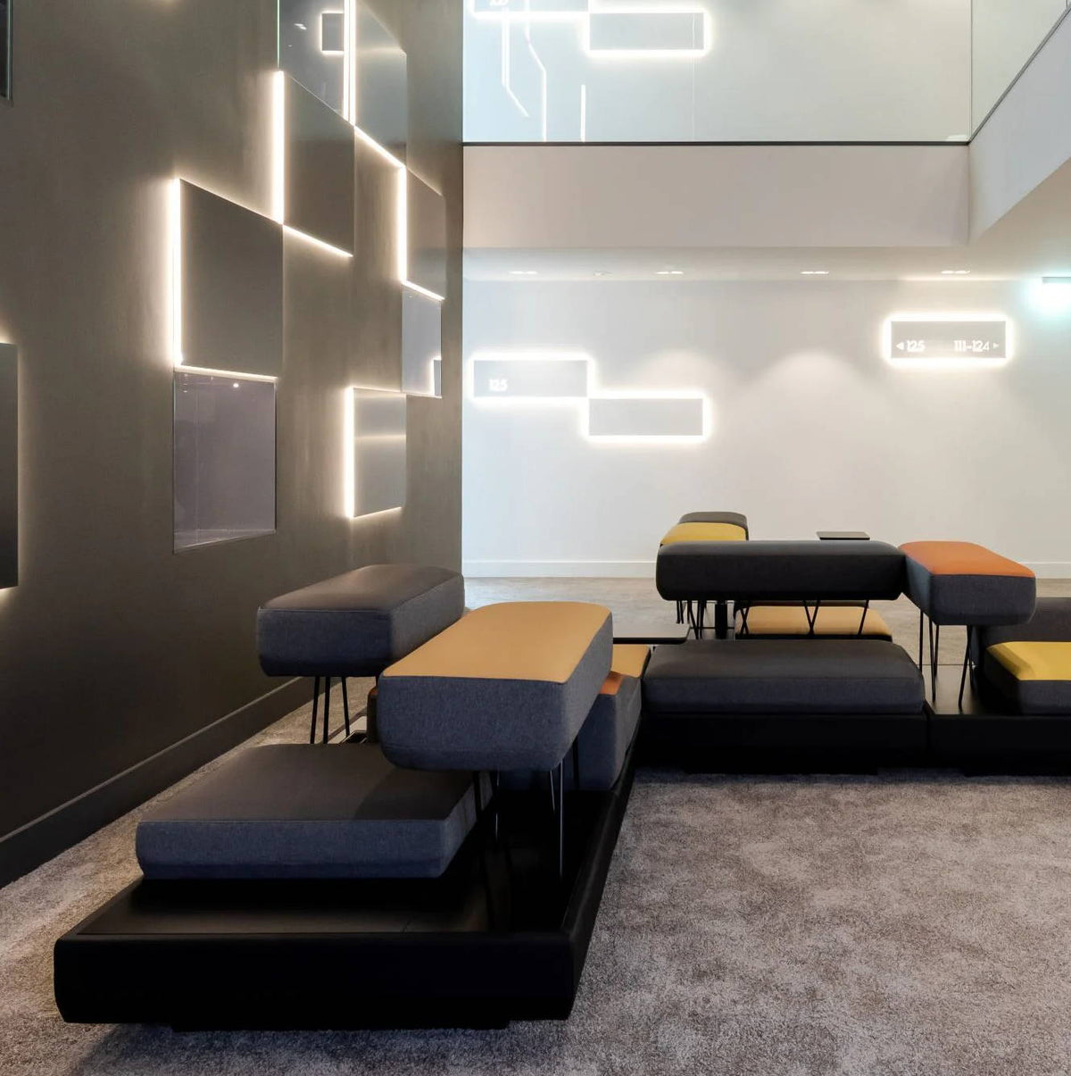 Au sein du KPM Hotel & Residences, un espace salon moderne doté d'un mobilier élégant et d'un éclairage d'ambiance.