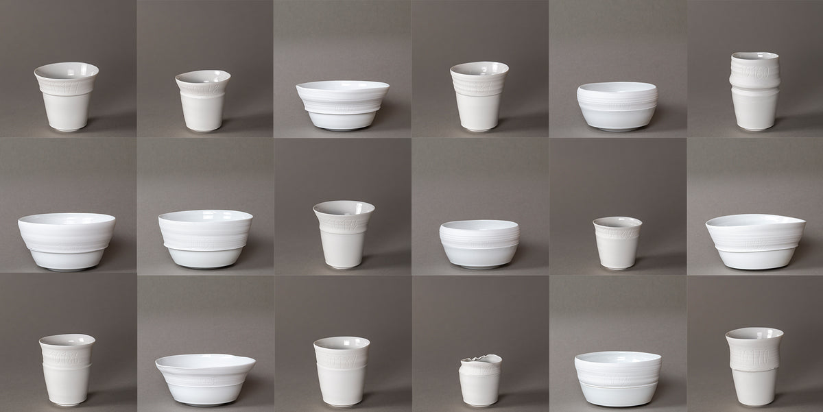 A collection of various white ceramic bowls and cups arranged in a grid.